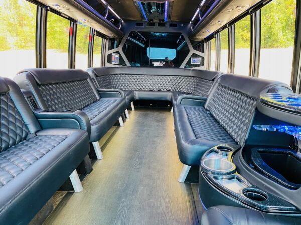 23 passenger luxury limo bus with surround seating and onboard PA system.