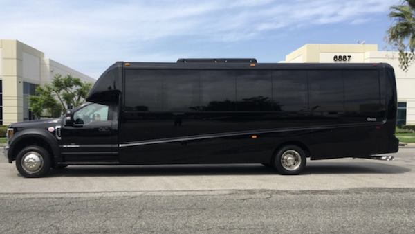 23 passenger limo bus side view.